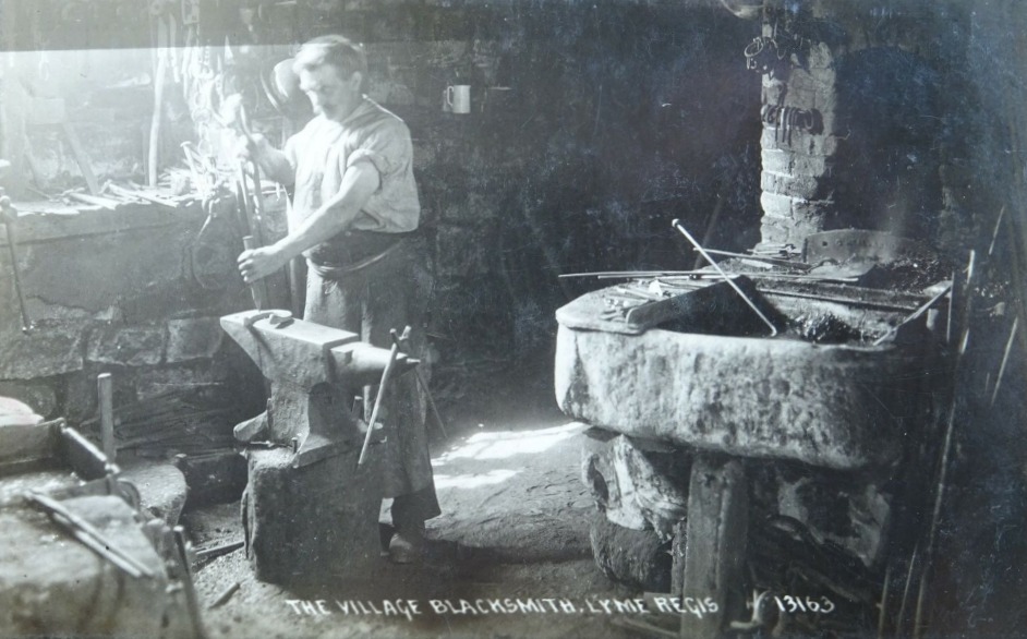 Vintage postcard of the village Blacksmith at work, Lyme Regis