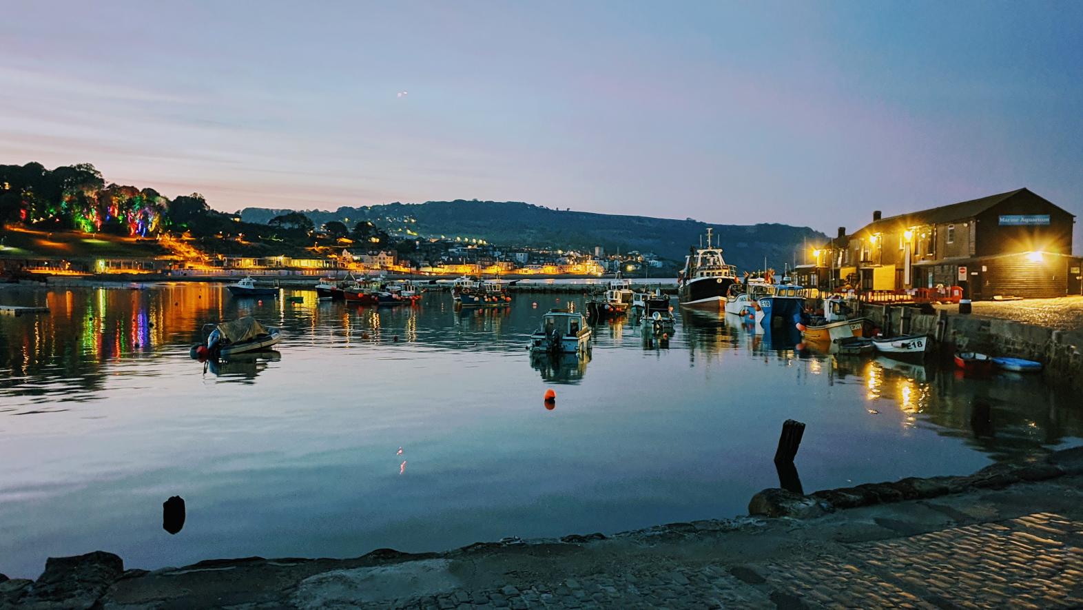 Lyme Regis harbour as night falls