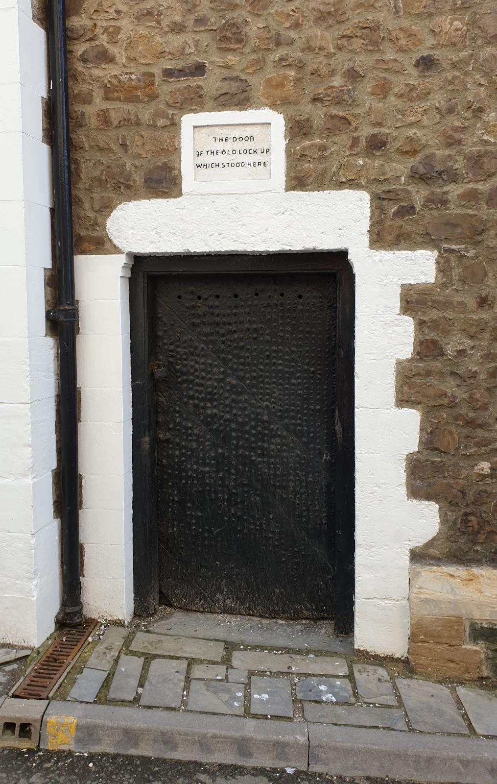 Old jail door outside The Guildhall Lyme Regis