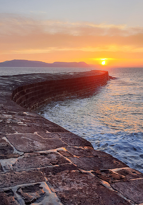 Sunrise viewed from the Cobb in Lyme Regis