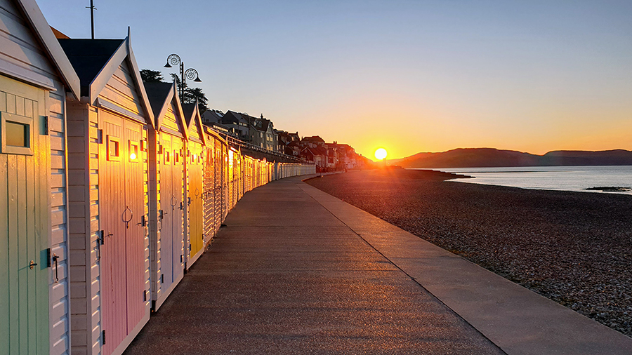Beach huts at sunrise in Lyme Regis