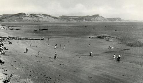View of Golden Cap from Lyme Regis beach circa 1950s