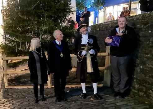 Joshua Denning switches on the lights accompanied by the Town Crier, Mayor and Mayoress