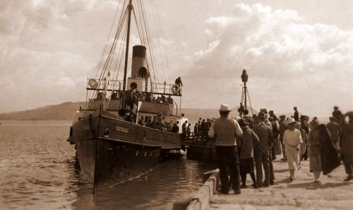 Paddle steamer Victoria landing at Lyme Regis